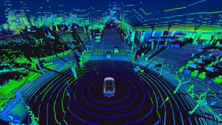 A LiDAR point cloud view from a self-driving car, showing a detailed 3D map of a city street at night with buildings, trees, and other cars visualized in glowing green and blue dots.
