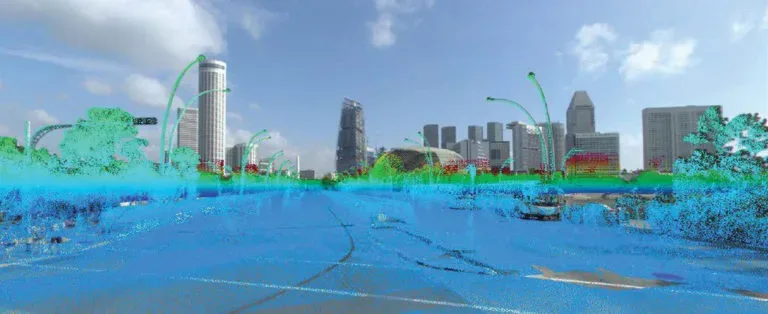 A composite image showing a real-world photograph of a modern city street with a colorful LiDAR point cloud overlay, demonstrating how the sensor data accurately maps the road, trees, and lampposts.