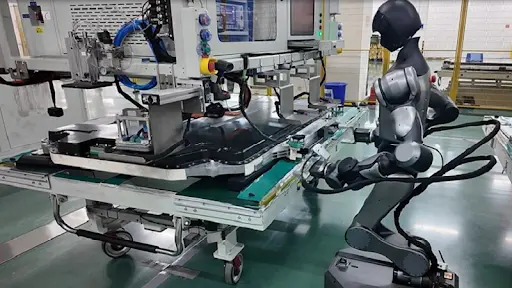 A humanoid robot working on a factory assembly line, handling a large industrial part, showcasing advanced manufacturing automation