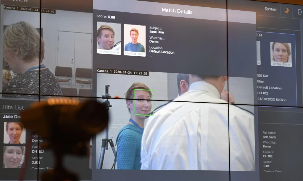 A security screen showing a facial recognition system matching a live camera feed to an enrolled photo on a watchlist