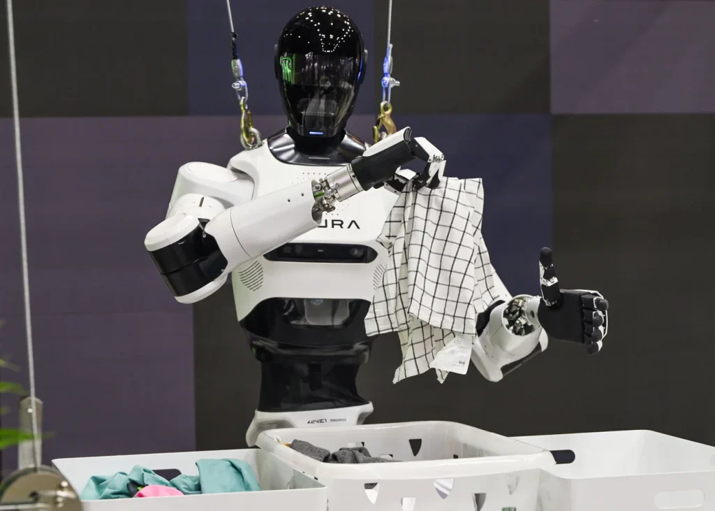 An advanced humanoid robot with dexterous hands carefully folding laundry, showcasing progress in AI-powered domestic robotics