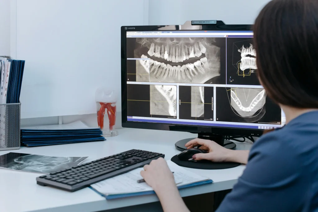 A radiologist or medical professional analyzing a digital dental X-ray on a computer, a key task for healthcare AI