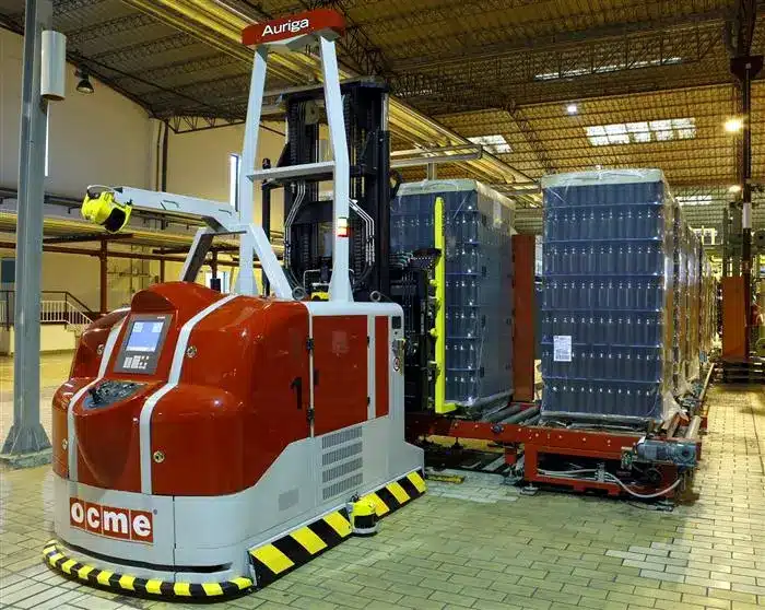 An autonomous laser-guided vehicle forklift transporting heavy pallets in a large warehouse