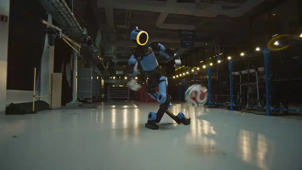 Boston Dynamics Atlas humanoid robot dynamically kicking a soccer ball in a test facility